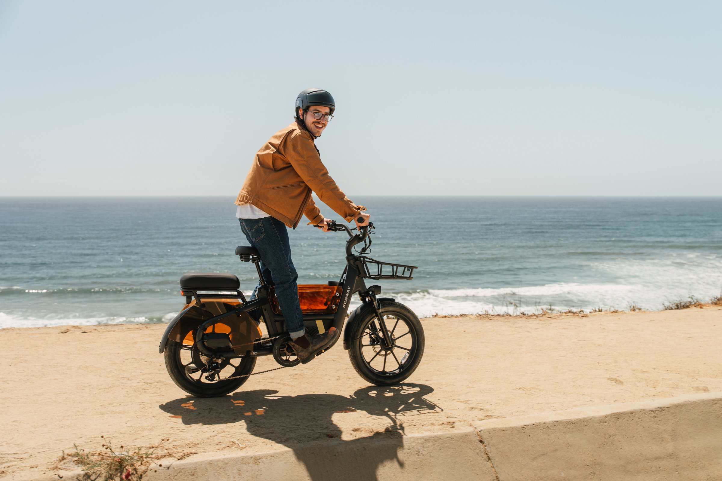 Rider on a Segway MUXI Pro e-bike along the beach