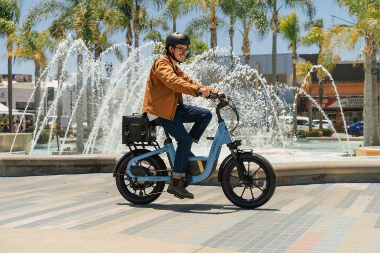 Rider on a Segway MUXI Pro cargo e-bike in a sunny city plaza