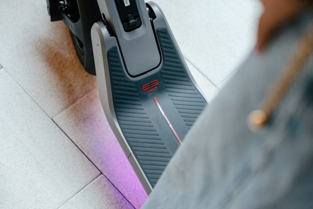 Close-up of the Segway E3 Pro deck with its RGB ambient light glowing underneath