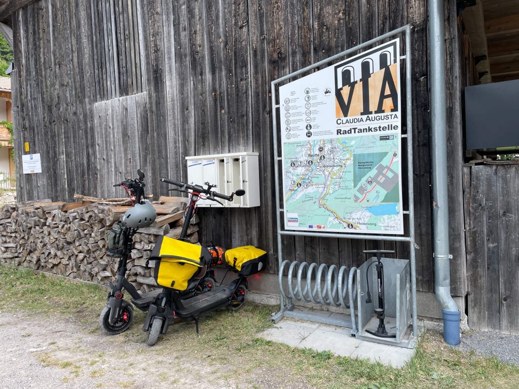 Segway MAX G3 electric scooter parked at a bicycle charging point along the Via Claudia Augusta
