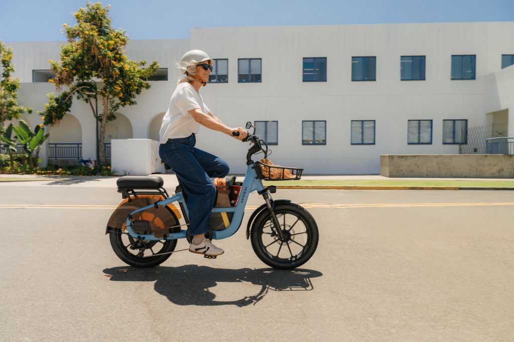 Rider sitting upright on a Reef Blue Segway MUXI Pro with its low-step frame