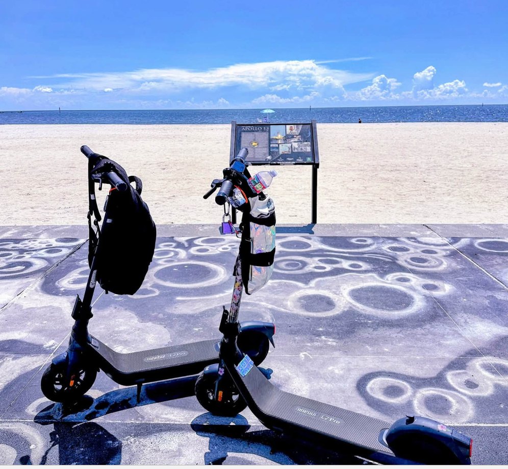 Two Segway E2 Pro electric scooters parked by the beach in Mississippi