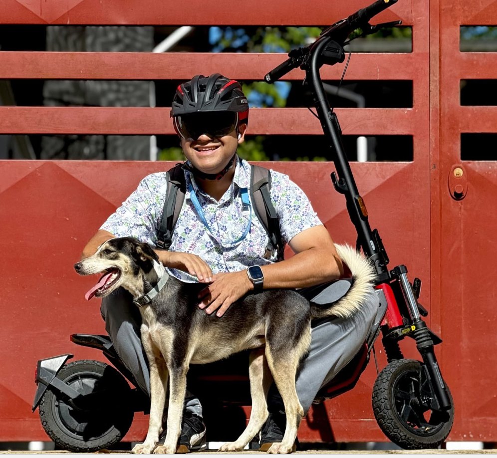 Rider and a friendly dog with a Segway ZT3 Pro electric scooter in Colombia