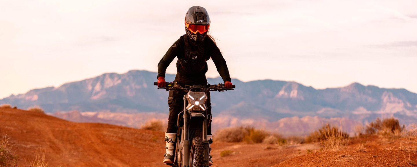 Rider on a Segway Xaber 300 electric dirt bike on a red dirt trail in Utah