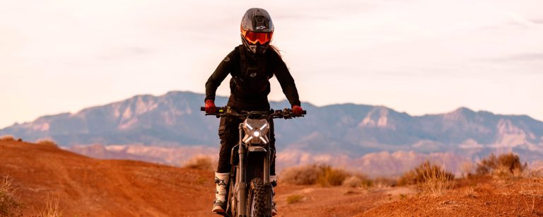 Rider on a Segway Xaber 300 electric dirt bike on a red dirt trail in Utah