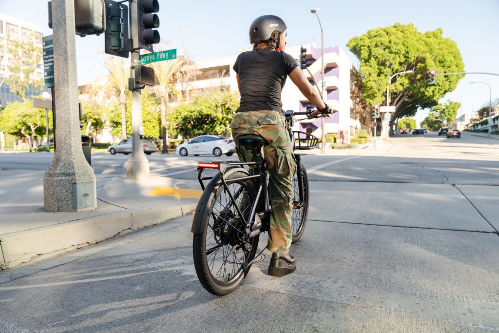 Rider stopped at a city curb on a Segway eBike fitted with the Xiro Automatic Dropper Post